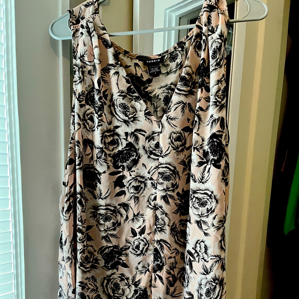 Flowing tank with delicate crochet shoulder detail.